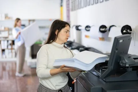 Technician working on plotter and cutter machine in printing shop Stock Photos