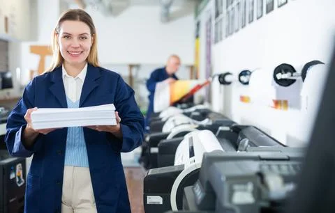 Technician working on plotter and cutter machine in printing shop Stock Photos