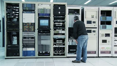Technician Working in Server Room With Network Equipment Stock Footage 83129624