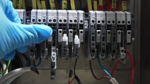 Technician Working with Terminal Blocks in Control Cabinet Stock Footage 346180449