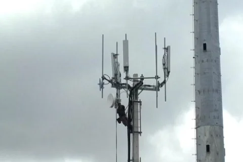 Technician working on top of cellular antenna tower 2 Stock Footage 773727