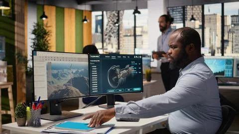Technician working on wind turbine simulation in office, doing upgrades Stock Photos