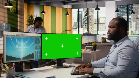 Technician works on power line tower CAD design on green screen PC in office Stock Footage 316000902