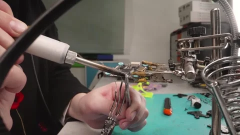 Technician works with precision on small electronic component Stock Footage 339278627