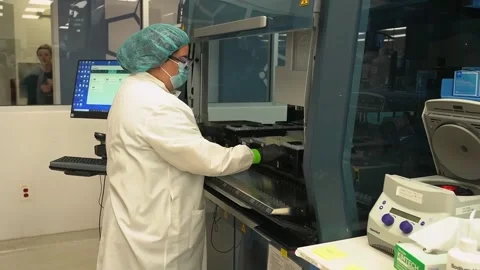A technician works at a screen beside laboratory instruments at a crime Video stock 345299241