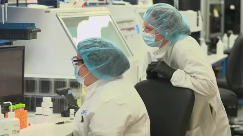 A technician works at a screen in a crime laboratory testing DNA samples Stock-Footage 345299165