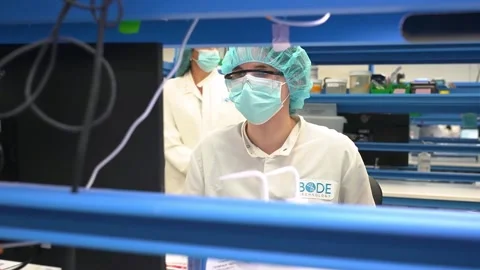 A technician at a workstation in a crime laboratory testing DNA samples Stock-Footage 345299213