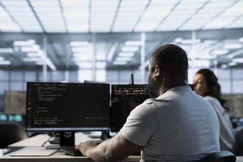 Technician writing code, safeguarding data center from unauthorized access Foto stock