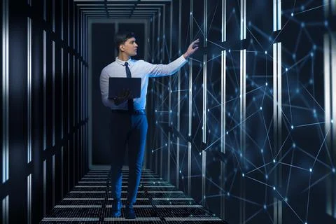 Technician/programmer holding a laptop in the server/data  room Stock Photos