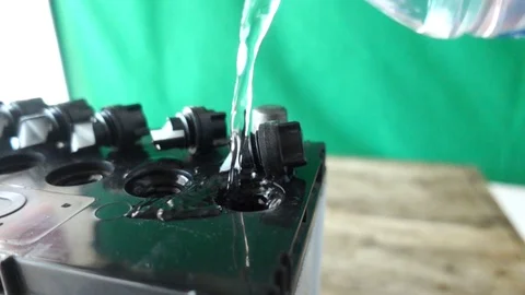 Technicians are adding distilled water to the battery with video slow motion, Stock Footage 109475048
