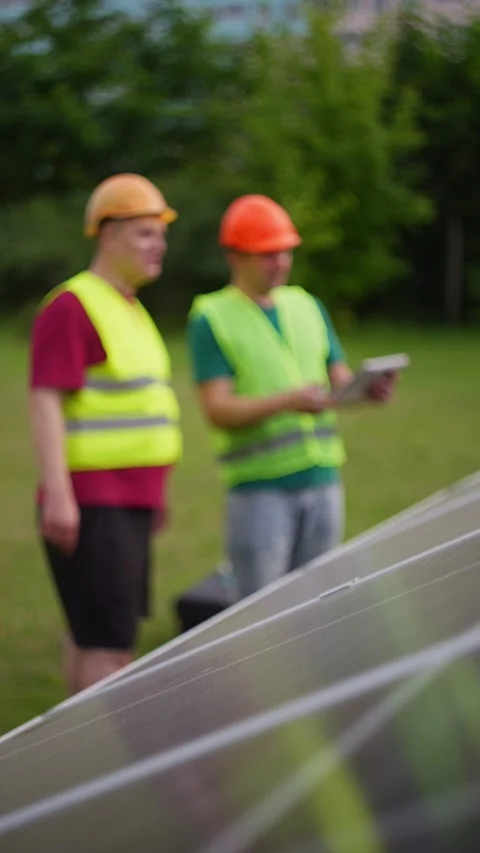 Technicians are adjusting solar panels under bright sunlight Stock Footage 313533367