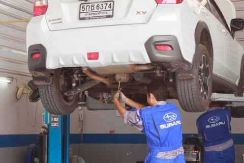 Technicians are changing engine oil to boost engine performance.Khonkaen.Thai Stock Photos