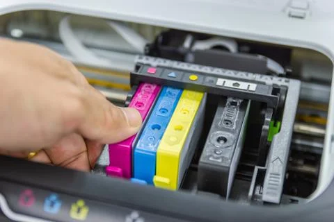 Technicians are install setup the ink cartridge or inkjet cartridge Stock Photos