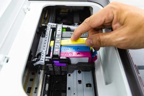 Technicians are install setup the ink cartridge or inkjet cartridge Photos
