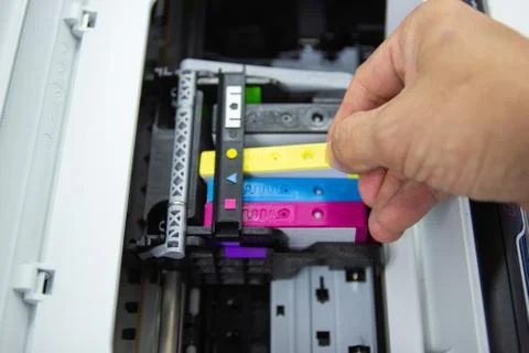 Technicians are install setup the ink cartridge or inkjet cartridge Photos