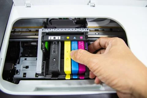 Technicians are install setup the ink cartridge of a inkjet printer Stock Photos