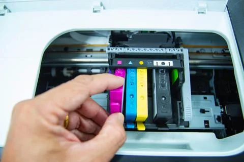 Technicians are install setup the ink cartridge of a inkjet printer Photos