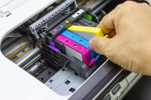 Technicians are install setup the ink cartridge of a inkjet printer Stock Photos