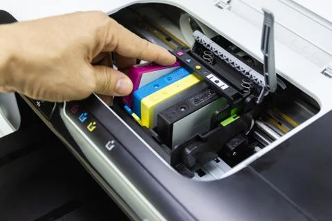 Technicians are install setup the ink cartridge of a inkjet printer Stock Photos