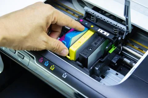 Technicians are install setup the ink cartridge of a inkjet printer Stock Photos