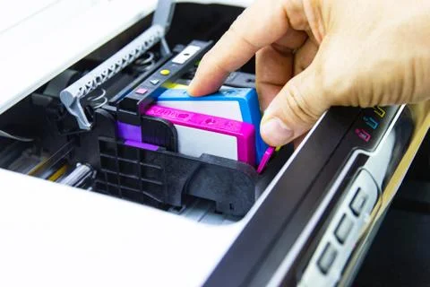 Technicians are install setup the ink cartridge of a inkjet printer Stock Photos