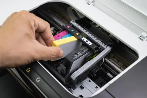 Technicians are install setup the ink cartridge of a inkjet printer Stock Photos