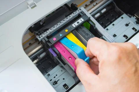 Technicians are install setup the ink cartridge of a inkjet printer Photos