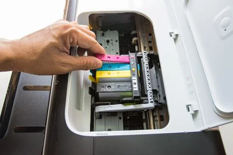 Technicians are install setup the ink cartridge of a inkjet printer Photos