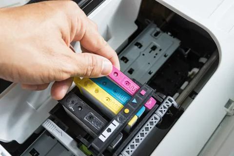 Technicians are install setup the ink cartridge of a inkjet printer Photos