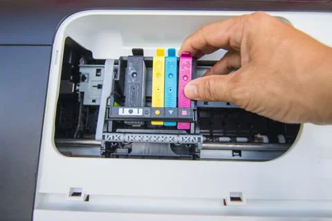 Technicians are install setup the ink cartridge of a inkjet printer Photos