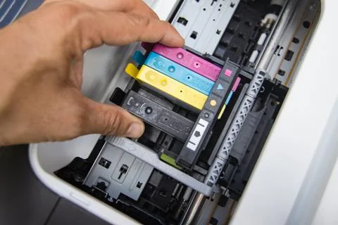 Technicians are install setup the ink cartridge of a inkjet printer Stock Photos