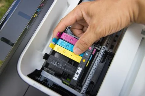 Technicians are install setup the ink cartridge of a inkjet printer Stock Photos