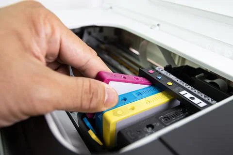 Technicians are install setup the ink cartridge of a inkjet printer Stock Photos