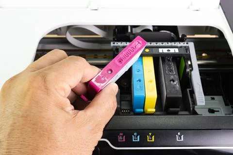 Technicians are install setup the ink cartridge of a inkjet printer Stock Photos
