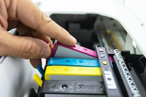 Technicians are install setup the ink cartridge of a inkjet printer Stock Photos