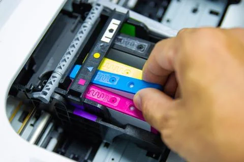 Technicians are installing the color printer inkjet cartridge Stock Photos