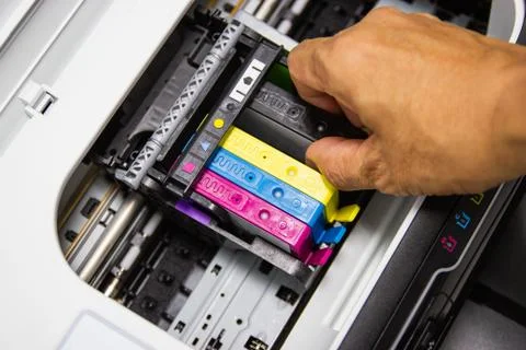 Technicians are installing the color printer inkjet cartridge Photos
