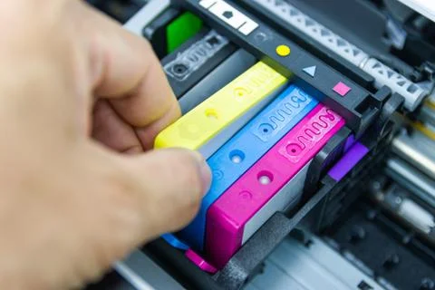 Technicians are installing the color printer inkjet cartridge Stock Photos