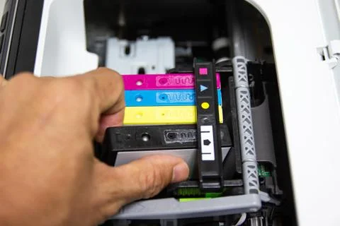 Technicians are installing the color printer inkjet cartridge Stock Photos