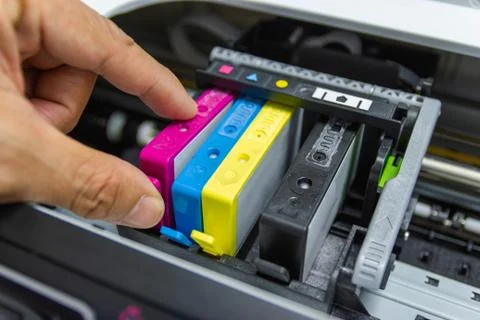 Technicians are installing the color printer inkjet cartridge Stock Photos
