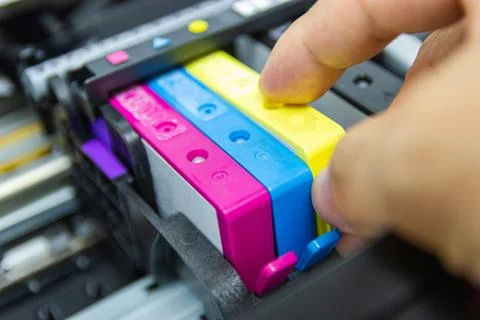 Technicians are installing the color printer inkjet cartridge Stock Photos