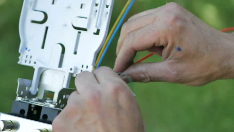 Technicians are installing optic fiber with cable ties. Stock Footage 89679263