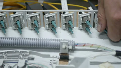 Technicians are installing optic fiber with cable ties. Stock Footage 97694672