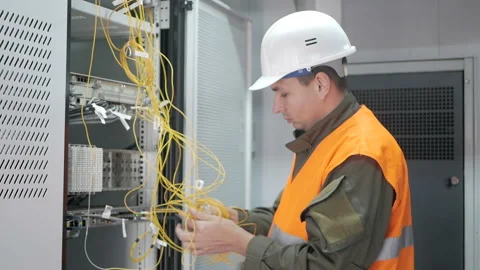 Technicians are installing optic fiber with cable ties. Stock Footage 98215193
