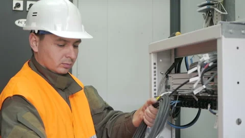 Technicians are installing optic fiber with cable ties. Stock Footage 98232975