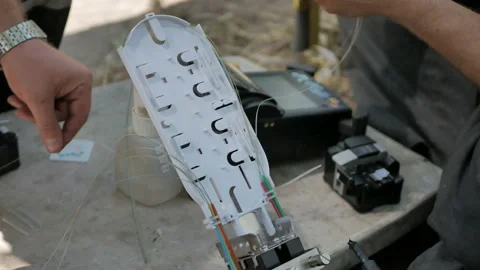 Technicians are installing optic fiber with cable ties. Stock Footage 150092496