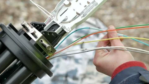 Technicians are installing optic fiber with cable ties. Stock Photos