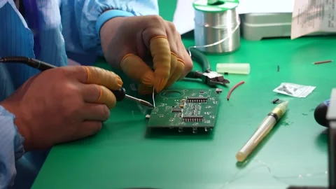 Technicians are using a soldering iron for repairing electronic of circuit board Stock Footage 287116896