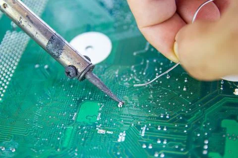 Technicians are using a soldering iron for repairing electronic 스톡 사진