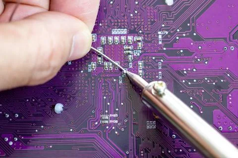 Technicians are using a soldering iron for repairing electronic Stock-Fotos